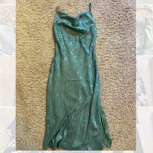small sage green lulus mid shin length dress with slit on left leg